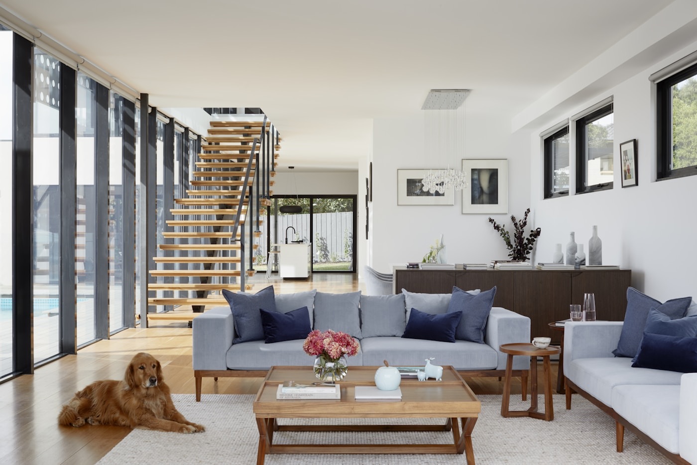 Bright home interior with visible stairs, windows, and living spaces